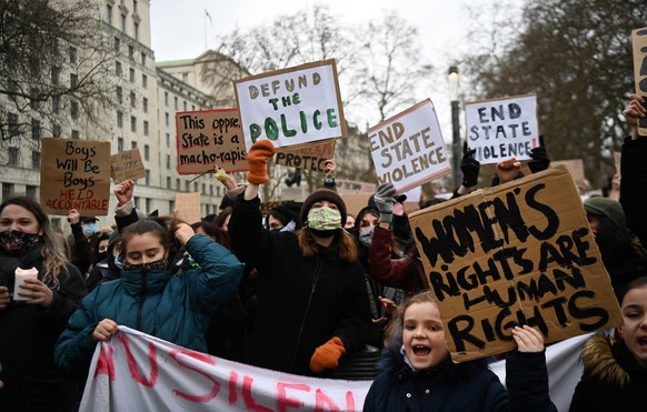 epa09074198 Protesters demonstrate outside Scotland Yard against police brutality in London, Britain, 14 March 2021. Thousands of people had attended a Reclaim These Streets vigil for Sarah Everard th ...