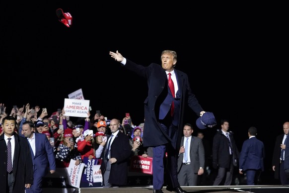 FILE - In this Wednesday, Sept. 30, 2020 file photo, President Donald Trump throws hats to supporters after speaking at a campaign rally at Duluth International Airport in Duluth, Minn. Trump���s rele ...