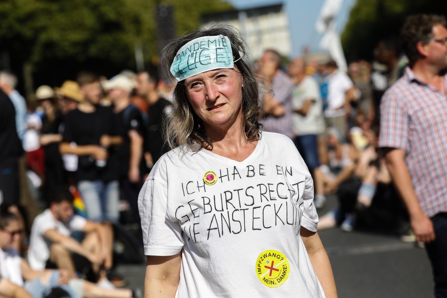 epa08579066 A woman wears a face mask reading &#039;pandemic lie&#039; on her forehead during a protest against coronavirus pandemic regulations in Berlin, Germany, 01 August 2020. An alliance of righ ...