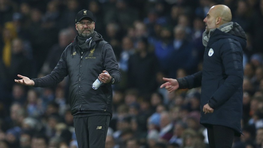 Liverpool&#039;s coach Juergen Klopp, left, and Manchester City&#039;s coach Pep Guardiola gesture from the side line during the English Premier League soccer match between Manchester City and Liverpo ...