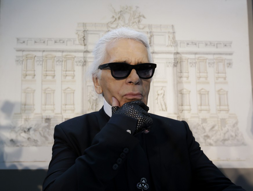 FILE - In this Monday, Jan. 28, 2013 file photo, Karl Lagerfeld poses for photographers prior to the start of a press conference, in Rome. Chanel&#039;s iconic couturier, Karl Lagerfeld, whose accompl ...