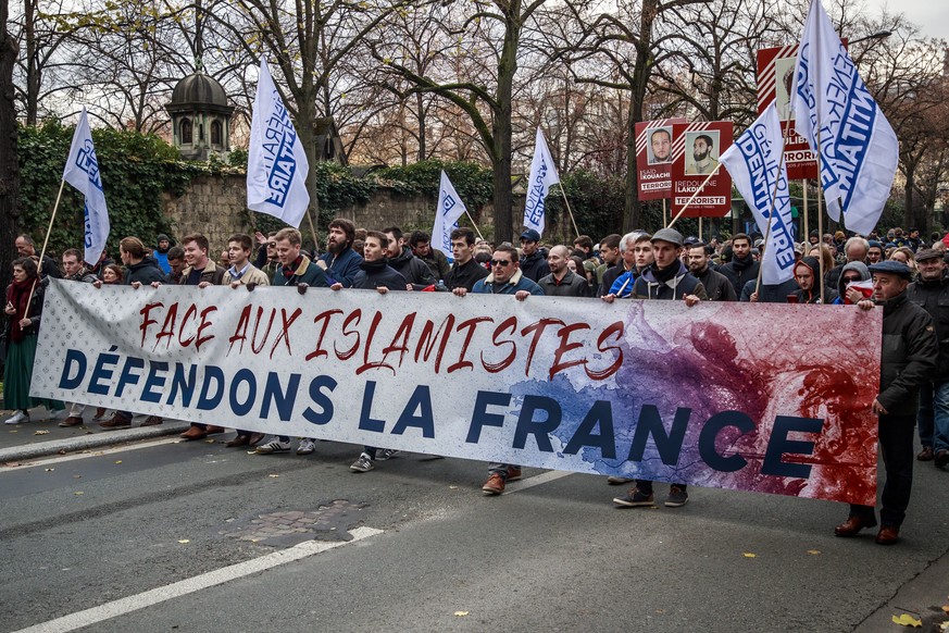 epa08003916 Members of far right group Generation Identitaire (GI), march behind a banner reading &#039;Face Islamists, Defend France&#039; during a demonstration against &#039;Islamization and terror ...