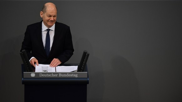 epa09154156 German Minister of Finance Olaf Scholz speaks during a session of the German Parliament ?Bundestag? in Berlin, Germany, 23 April 2021. The German Parliament ?Bundestag? discusses a supplem ...