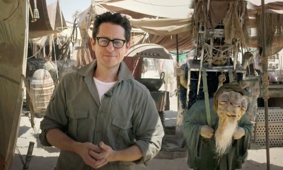 In this video grab made available by Lucasfilm Ltd. &amp; TM on Thursday, May 22, 2014, J.J. Abrams, director of &quot;Star Wars: Episode VII,&quot; talks to the fans from the movie set in the desert  ...