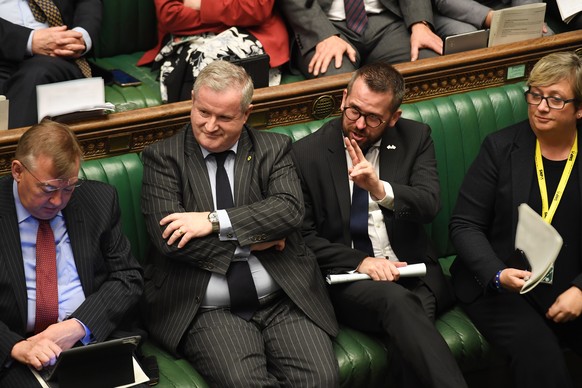 epa07939200 A handout picture made available by the UK Parliament shows The Scottish National Party (SNP) Westminster leader, Ian Blackford (C) during a debate in the House of Commons in London, Brita ...