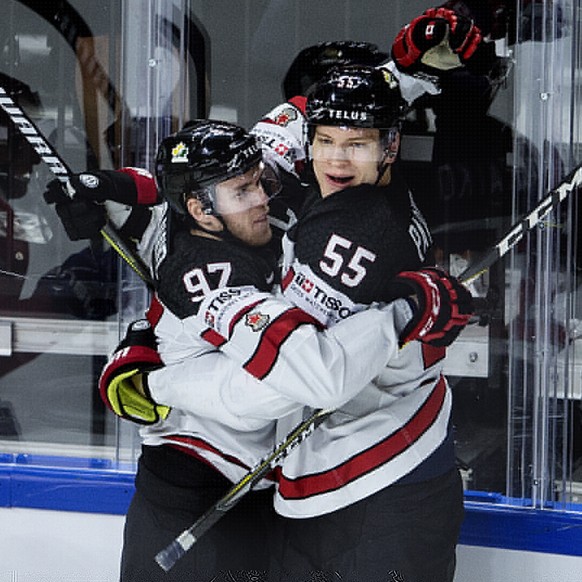epa06744958 Colton Parayko (R) and Connor McDavid (C) of Canada celebrate the 1-0 lead during the IIHF World Championship quarter final ice hockey match between Russia and Canada at Royal Arena in Cop ...