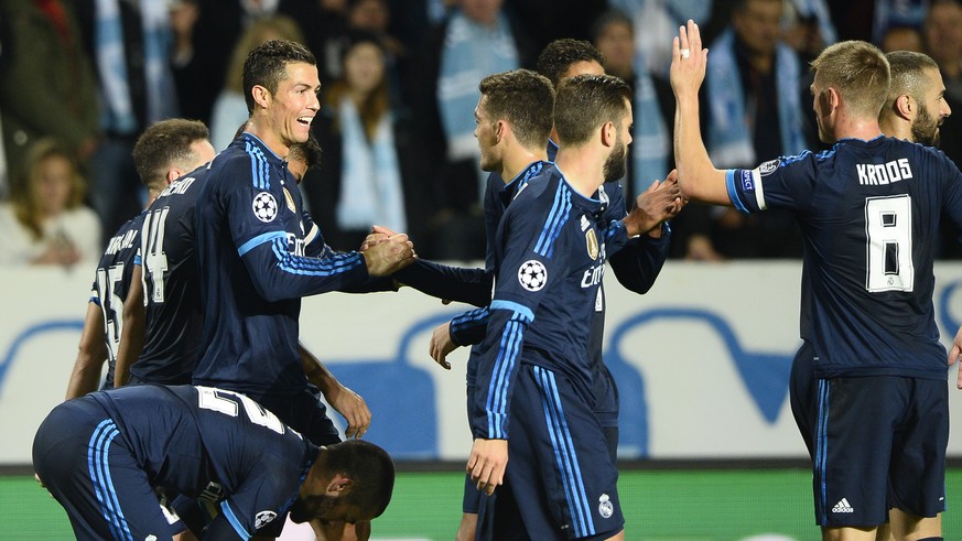 Real Madrid&#039;s Cristiano Ronaldo, left, celebrates with team mates after scoring the opening goal during the UEFA Champions League group A football match between Malmo FF and Real Madrid at Malmo  ...