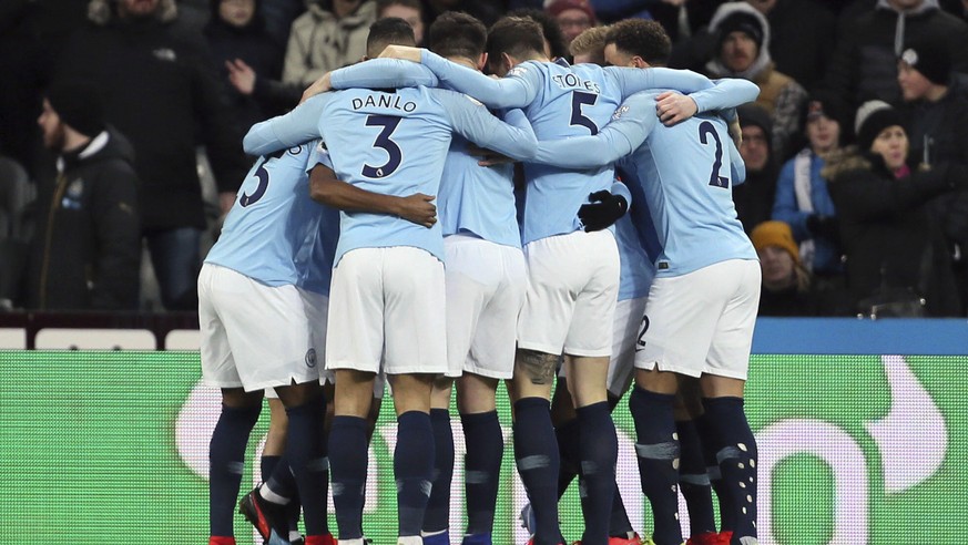 Manchester City players celebrate after Sergio Aguero, hidden, scored his side&#039;s first goal of the game against Newcastle, during their English Premier League soccer match at St James&#039; Park  ...