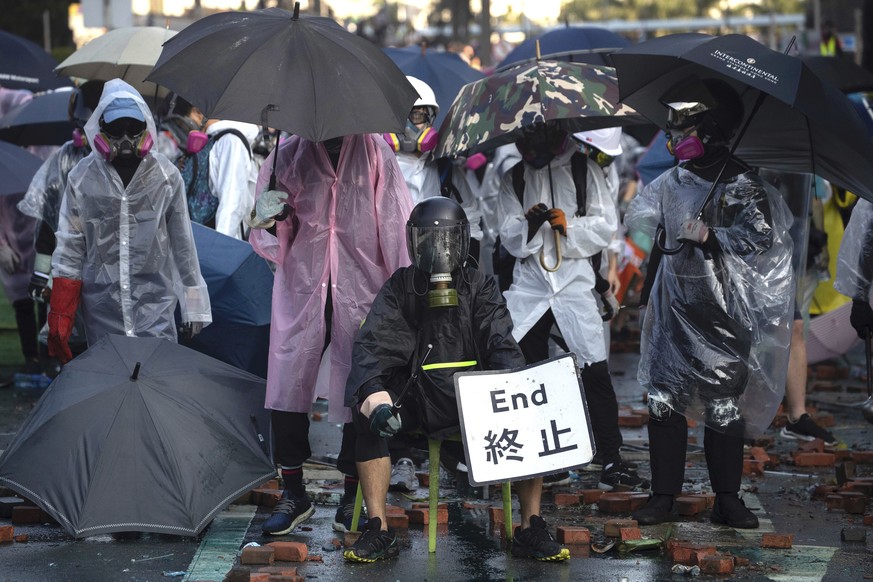 Protestors gather near Hong Kong Polytechnic University in Hong Kong, Sunday, Nov. 17, 2019. A Hong Kong police officer was hit in the leg by an arrow Sunday as authorities used tear gas and water can ...