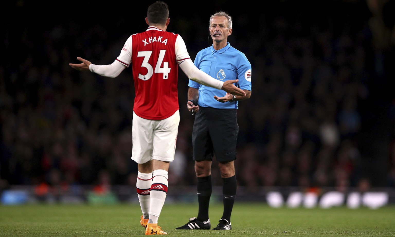 Arsenal&#039;s Granit Xhaka speaks to referee Martin Atkinson during the English Premier League soccer match at the Emirates Stadium, London, Sunday Oct. 27, 2019. (Nigel French/PA via AP)