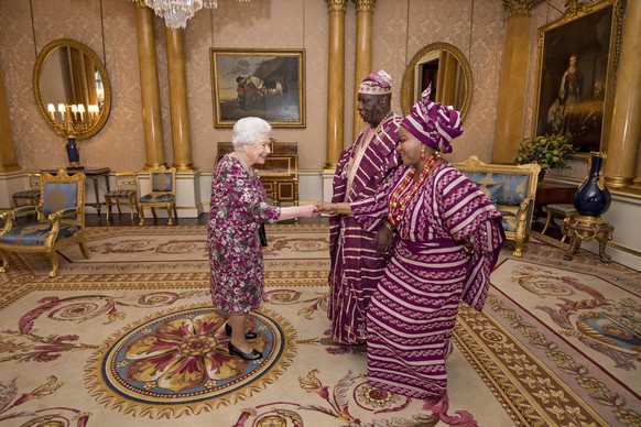 Britain&#039;s Queen Elizabeth II meets Mr George Adesola Oguntade, the High Commissioner of the Federal Republic of Nigeria, as he presents his Letter of Credence with his wife Mrs Oguntade during a  ...