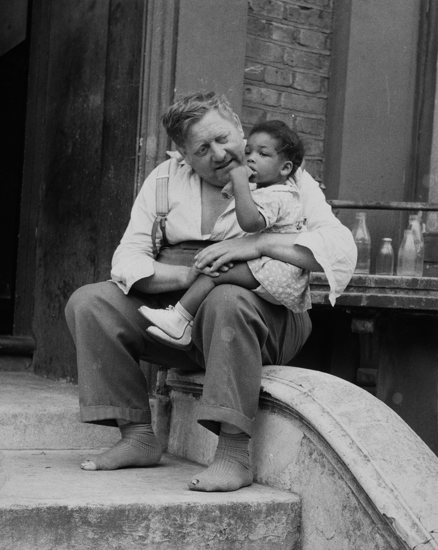 A man holding a girl in Notting Hill during the race riots, London, UK, 3rd September 1958. (Photo by Daily Express/Pictorial Parade/Hulton Archive/Getty Images)