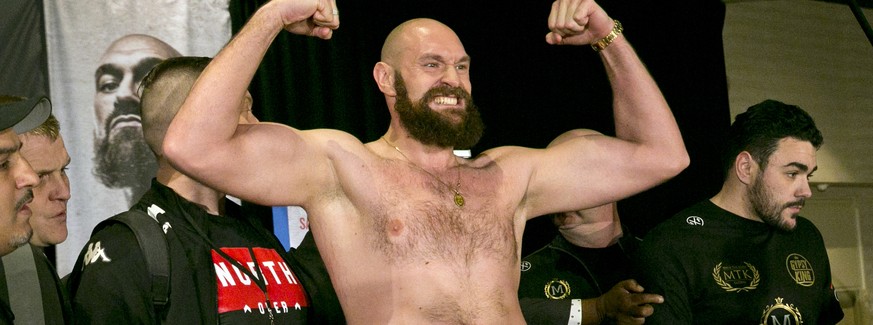 Boxer Tyson Fury flexes after exchanging words with opponent Deontay Wilder at a news conference in Los Angeles, Wednesday, Nov. 28, 2018, ahead of their heavyweight world championship boxing match at ...