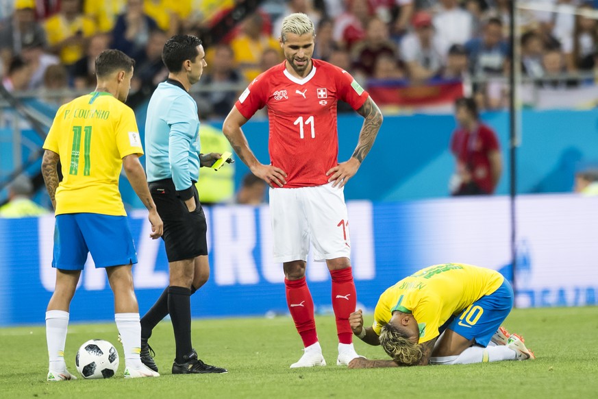 Brazil&#039;s midfielder Philippe Coutinho, left, Switzerland&#039;s midfielder Valon Behrami, center, react next to Brazil&#039;s forward Neymar, right, during the FIFA soccer World Cup 2018 group E  ...