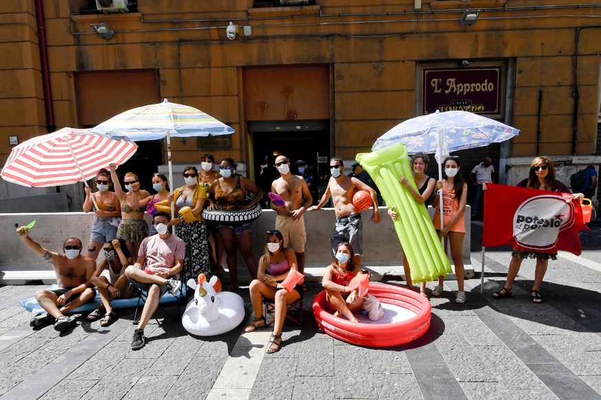 epa08570421 People gather outside the headquarters of Campania region to protest against the higher prices to access beaches in Naples, Italy, 28 July 2020. Following the social distance measures impo ...