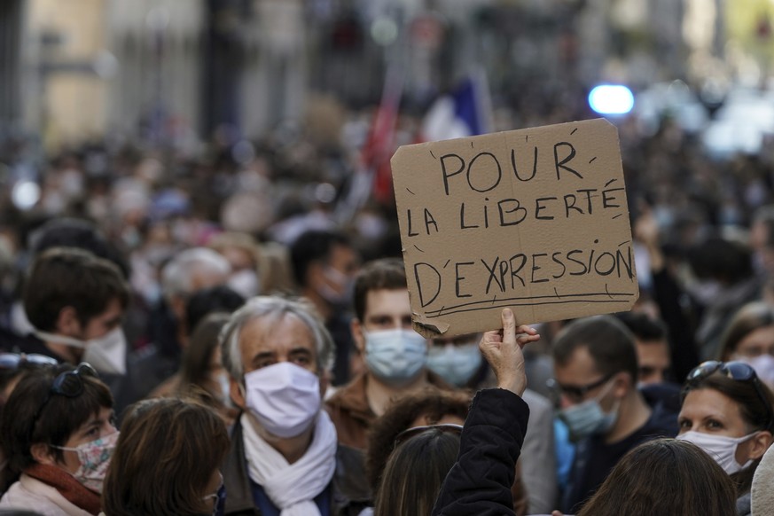 A person holds up a banner that reads: &#039;For the freedom of speech&#039;, during a demonstration in Lyon, central France, Sunday, Oct. 18, 2020. Demonstrators in France on Sunday took part in gath ...