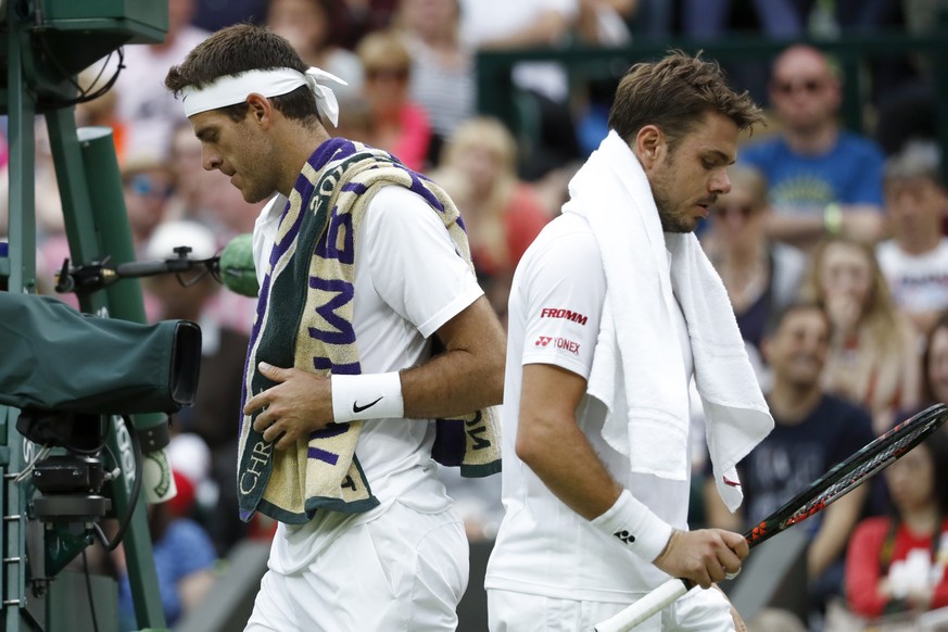 Stan Wawrinka of Switzerland, right, and Juan Martin Del Potro of Argentina, left, during their second round match, at the All England Lawn Tennis Championships in Wimbledon, London, Friday, July 1, 2 ...