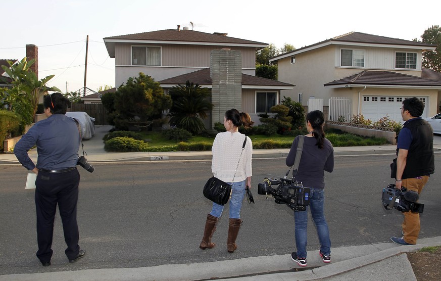 Japanese media wait outside the residence, left, of Dorian S. Nakamoto Thursday March 6, 2014, in Temple City, Calif. Nakamoto, the man that Newsweek claims is the founder of Bitcoin denies he had any ...