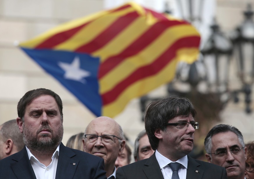 FILE - In this Monday, Oct. 2, 2017 file photo, Catalan regional Vice-President, Oriol Junqueras, left, and Catalan President, Carles Puigdemont, attend a protest called by pro-independence supporters ...