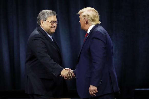 President Donald Trump shakes hands with Attorney General William Barr before Trump signed an executive order creating a commission to study law enforcement and justice at the International Associatio ...