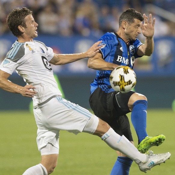 Montreal Impact&#039;s Blerim Dzemaili, right, challenges Minnesota United FC&#039;s Collin Martin during first half MLS soccer action in Montreal, Saturday, Sept. 16, 2017. (Graham Hughes/The Canadia ...