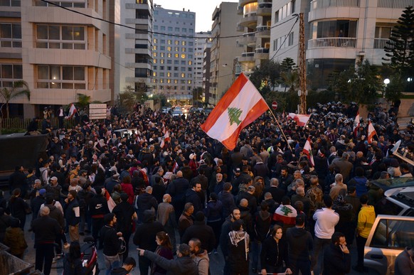 epa08127837 Anti-government protesters shout slogans as they take part in protest against the nomination of Hassan Diab as Prime Minister, outside his house in Beirut, Lebanon, 14 January 2020. After  ...