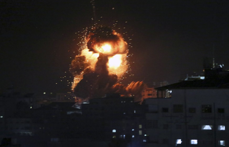 An explosion caused by Israeli airstrikes is seen from the offices of Hamas leader Ismail Haniyeh, in Gaza City, Monday, March 25, 2019. Israeli forces on Monday struck targets across the Gaza Strip i ...