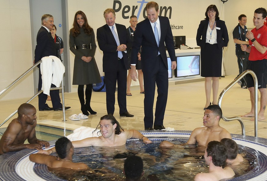 Britain&#039;s Prince William standing centre, talks England soccer players in the water at the hyrotherapy suite during the official launch of The Football Association&#039;s National Football Centre ...