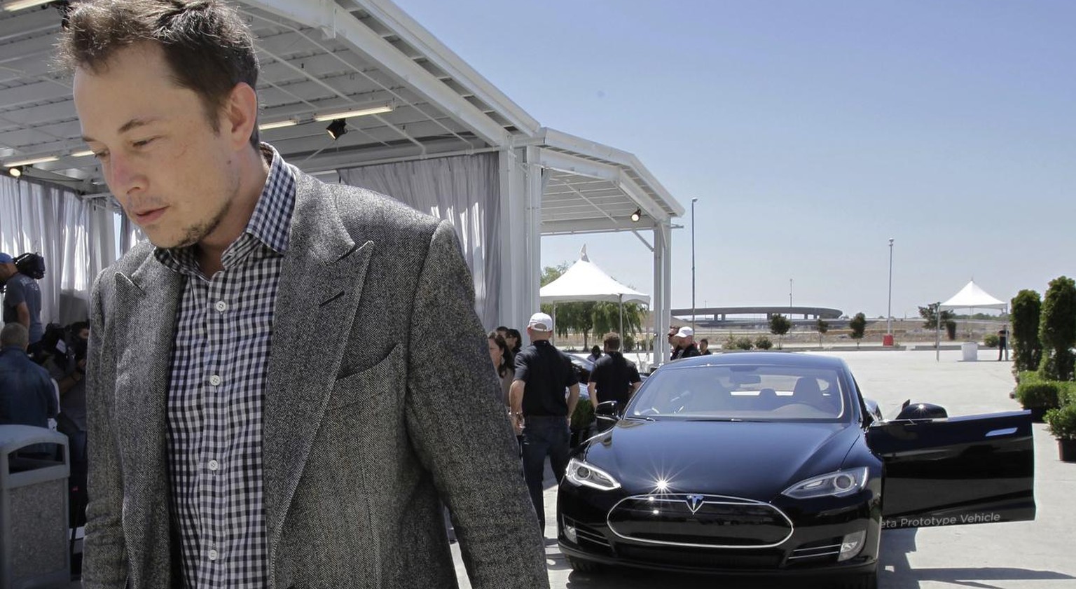 FILE - In this Friday, June 22, 2012 file photo, Tesla CEO Elon Musk walks past the Tesla Model S after a news conference at the Tesla factory in Fremont, Calif. Musk on Tuesday, Nov. 5, 2013, blamed  ...