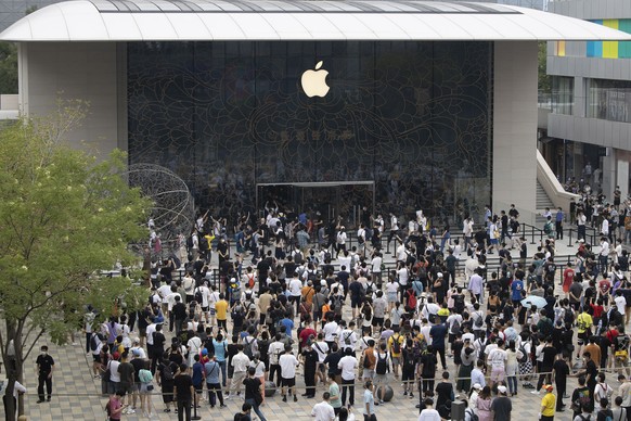 Apple fans cheer as the doors to a new flagship store are opened at Sanlitun in Beijing, China on Friday, July 17, 2020. China&#039;s economy rebounded from a painful contraction to grow by 3.2% over  ...