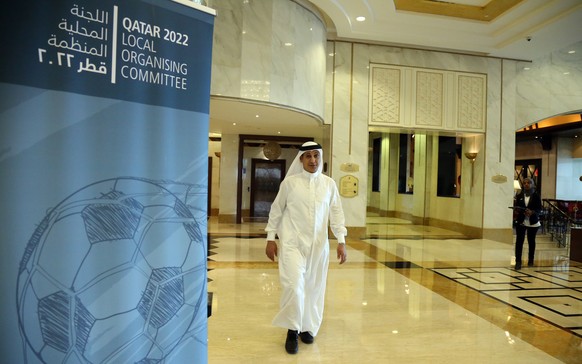 A man walks past the venue where FIFA officials met members of the Qatar 2022 local organizing committee to discuss matters relating to the rescheduling of the World Cup from summer to winter, in Doha ...