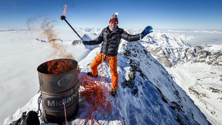Pirmin Zurbriggen, former alpine ski racing champion from Switzerland, lights a symbolic torch in support of the &quot;Sion 2026&quot; winter Olympic Games candidacy project, on the summit of the icon ...