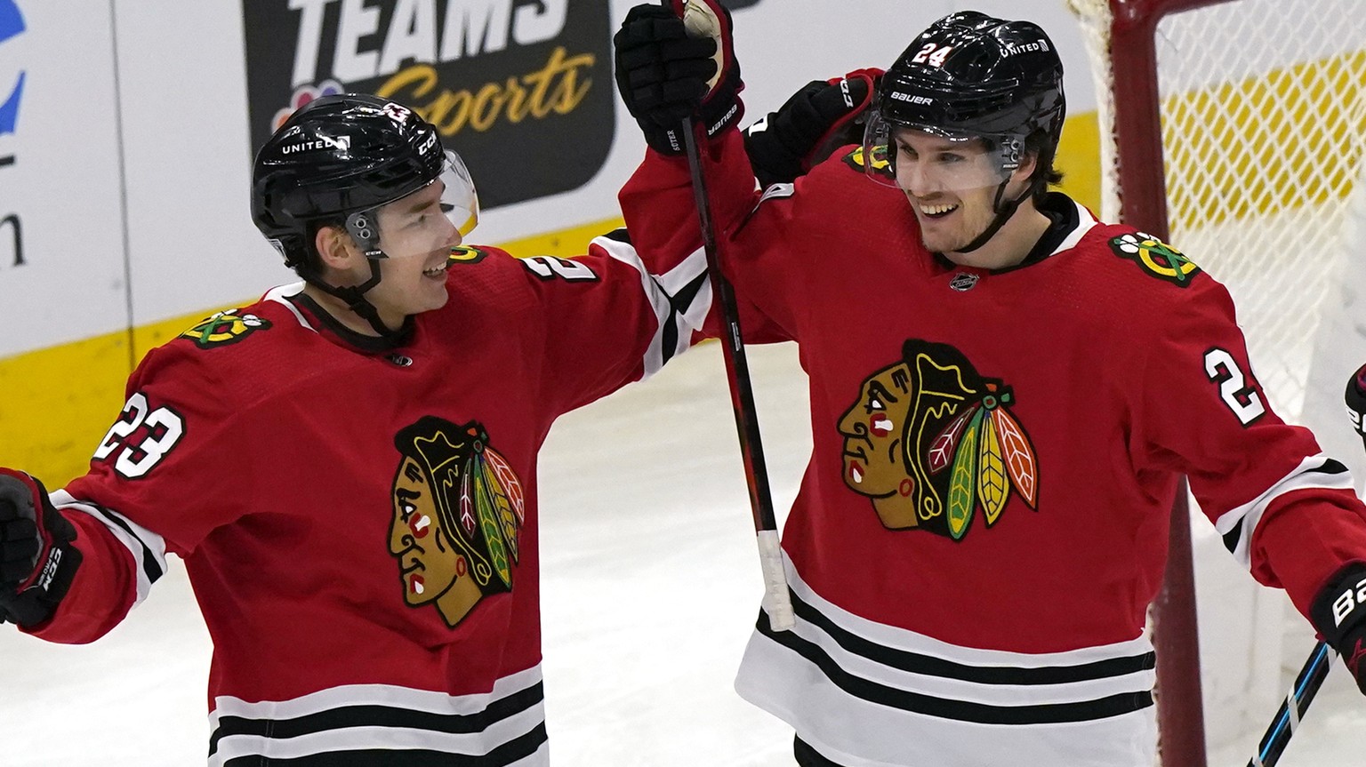 Chicago Blackhawks center Pius Suter, right, celebrates with left-wing Philipp Kurashev after scoring his second goal against the Detroit Red Wings during the first period of an NHL hockey game in Chi ...