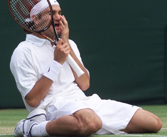 Roger Federer of Switzerland falls to his knees, as he defeats defending champion Pete Sampras in their men&#039;s singles, fourth round match on the Centre Court at Wimbledon, Monday July 2, 2001. (K ...