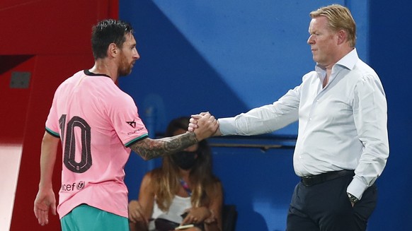 Barcelona&#039;s Lionel Messi, left, shakes hands as he is substituted with Barcelona&#039;s coach Ronald Koeman as he is substituted during the pre-season friendly soccer match between Barcelona and  ...