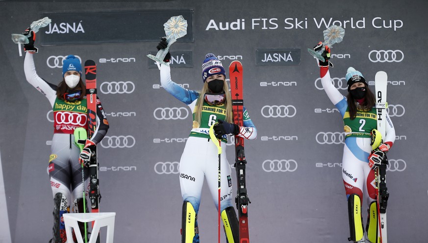 United States&#039; Mikaela Shiffrin, center, winner of the alpine ski World Cup women&#039;s slalom, celebrates on the podium with second placed Slovakia&#039;s Petra Vlhova, left, and third placed S ...