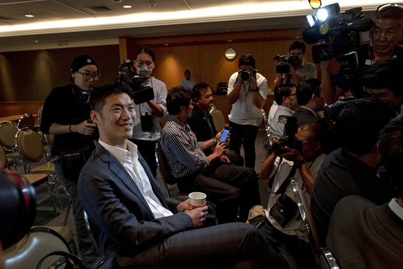 Future Forward Party leader Thanathorn Juangroongruangkit sits to watch a live television broadcast of a court verdict on whether to dissolute his party at their party&#039;s headquarters in Bangkok,  ...