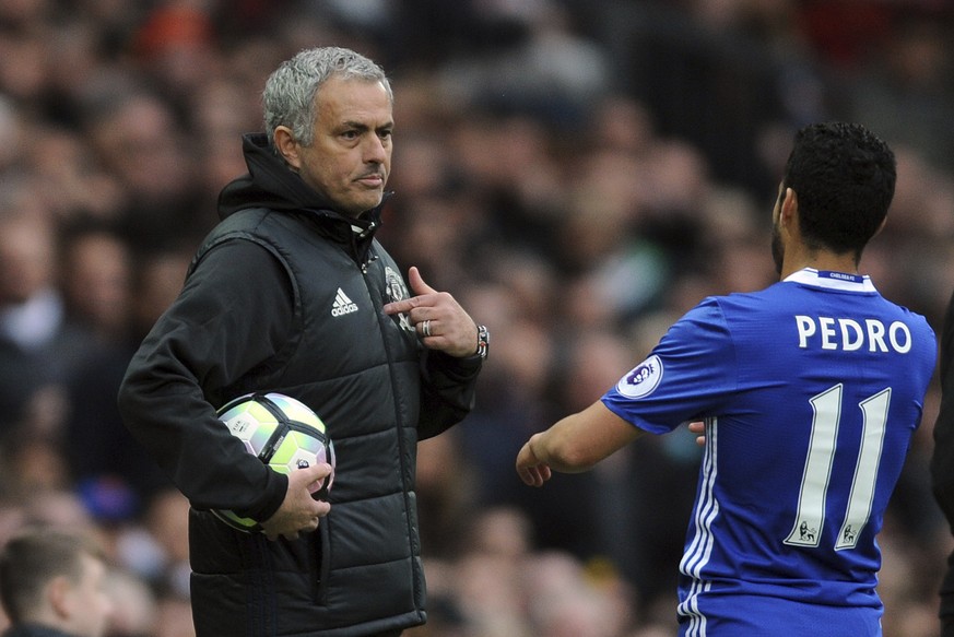Manchester United&#039;s team manager Jose Mourinho, left, talks to Chelsea&#039;s Pedro during the English Premier League soccer match between Manchester United and Chelsea at Old Trafford stadium in ...