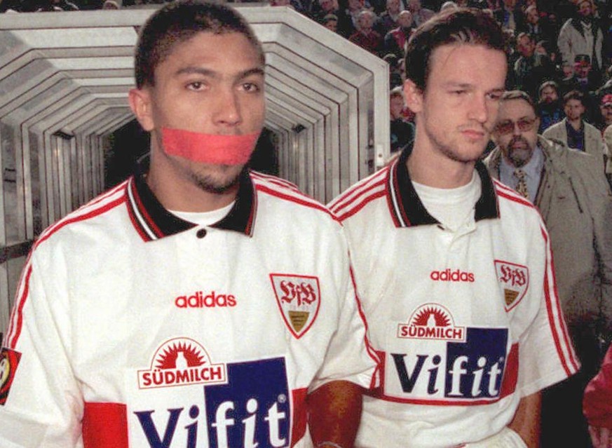 Giovane Elber (L) of VfB Stuttgart comes of the cubicles for the second half with a piece of tape over his mouth during the German Bundesliga match between Stuttgart and 1860 Munich at Gottlieb-Daimle ...