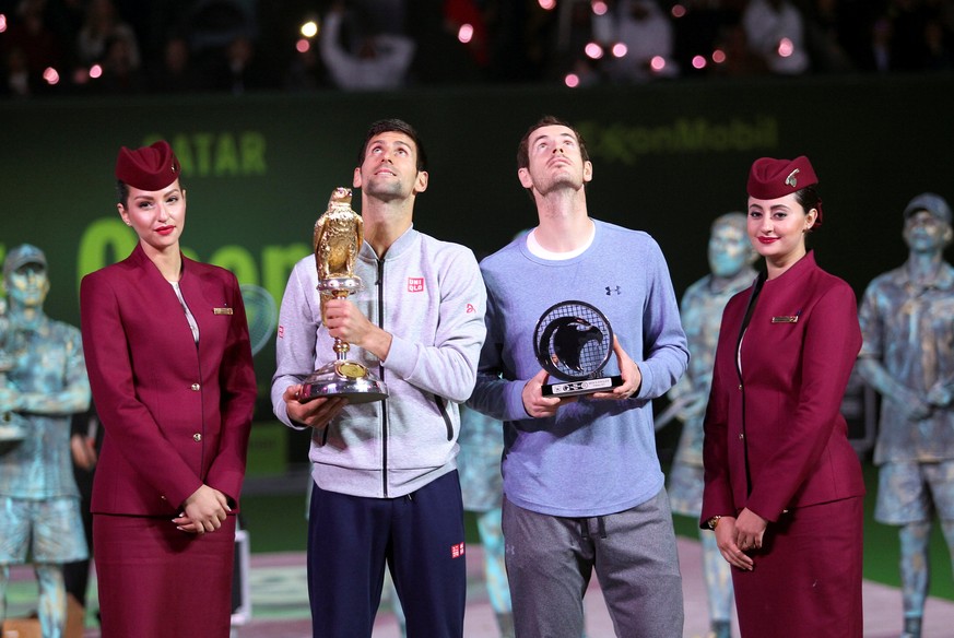 Tennis - Qatar Open - Men&#039;s singles final - Andy Murray of Britain v Novak Djokovic of Serbia - Doha, Qatar - 7/1/2017 - First-placed Djokovic and second-placed Murray hold the trophies. REUTERS/ ...