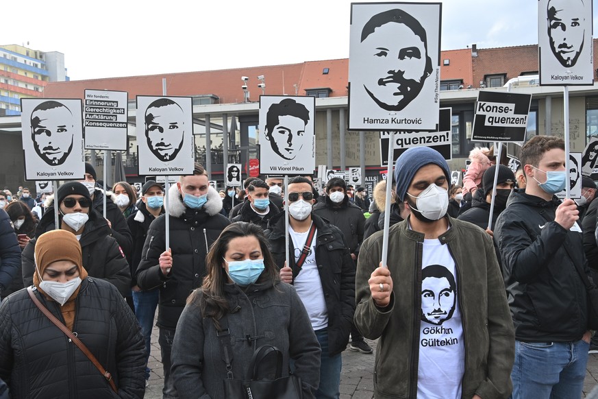 epa09023933 Participants of a demonstration commemorating the victims of a right-wing extremist shooting in February 2020 hold signs with names and images of the victims in Hanau, Germany, 19 February ...