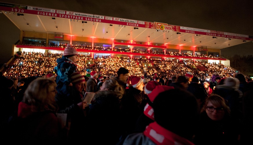 Some 27,000 people take part in the annuall Christmas carol singing event at the stadium of German second division Bundesliga football club 1 FC Union Berlin on December 23, 2014 in Berlin. AFP PHOTO  ...