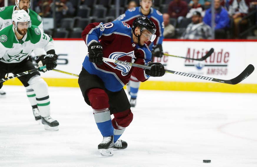 Colorado Avalanche right wing Sven Andrighetto, front, of Switzerland, takes a shot on the net as Dallas Stars center Tyler Seguin defends in the first period of an NHL hockey game Tuesday, Oct. 24, 2 ...