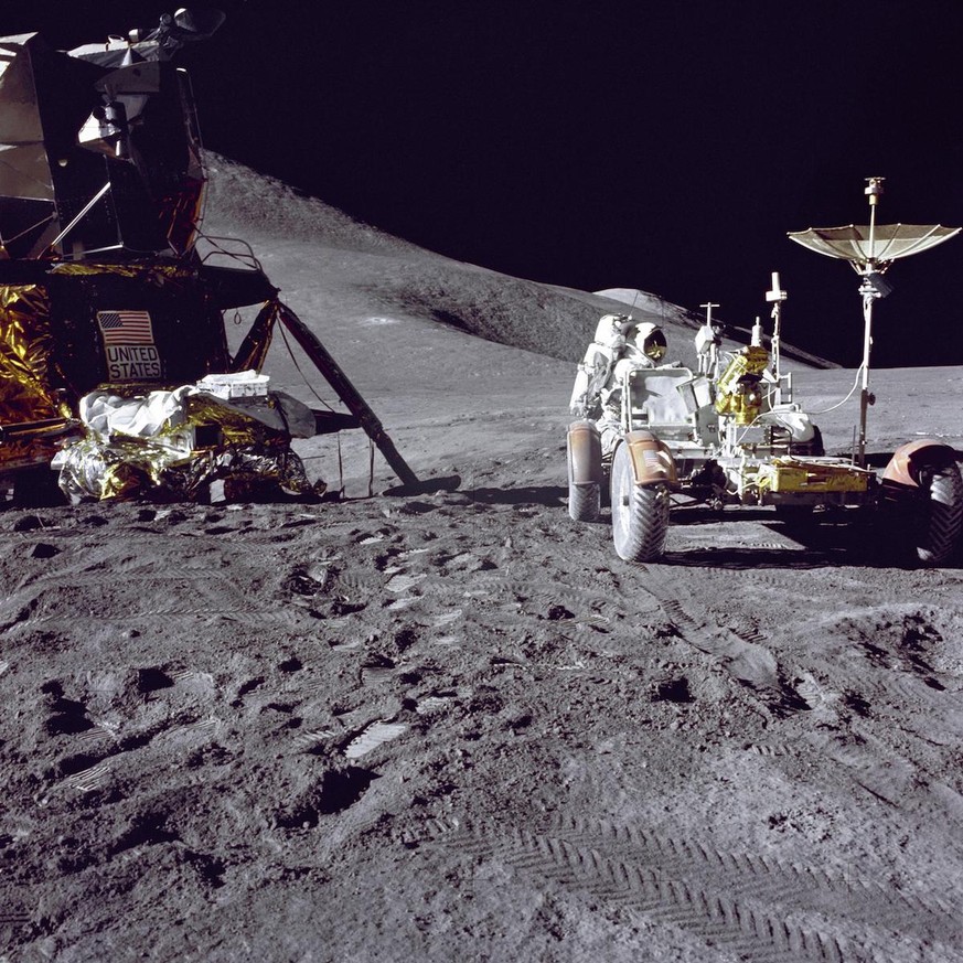 Apollo 15 lunar module pilot Jim Irwin loaded the lunar rover with tools and equipment in preparation for the first lunar spacewalk at the Hadley-Apennine landing site. The Lunar Module &#039;Falcon&# ...