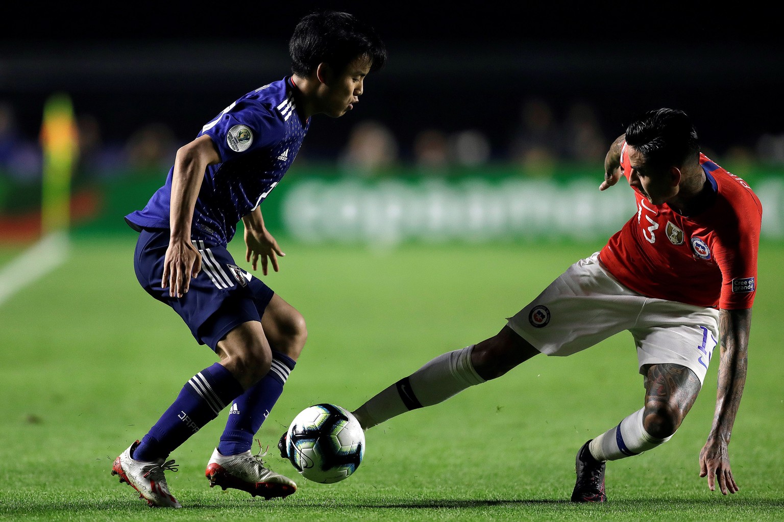 epa07654828 Takefusa Kubo (L) of Japan in action against Erick Pulgar (R) of Chile during the Copa America 2019 Group C soccer match between Japan and Chile, at Morumbi Stadium in Sao Paulo, Brazil, 1 ...