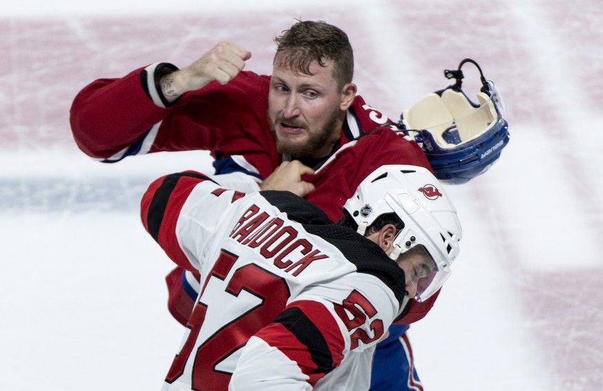 Montreal Canadiens&#039; Nicolas Deslauriers, top, and New Jersey Devils&#039; Brandon Baddock square off during first-period preseason NHL hockey game action Monday, Sept. 17, 2018, in Montreal. (Pau ...