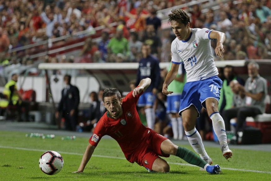 Portugal&#039;s Bernardo Silva, left, falls in front of Italy&#039;s Federico Chiesa during the UEFA Nations League soccer match between Portugal and Italy at the Luz stadium in Lisbon, Monday, Sept.  ...