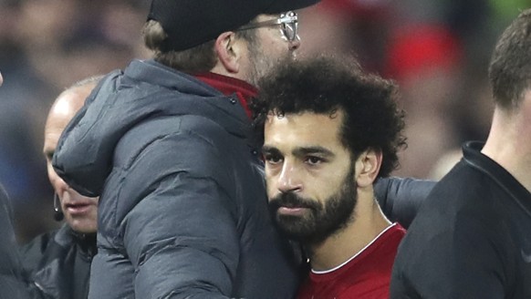 Liverpool&#039;s manager Jurgen Klopp hugs with Liverpool&#039;s Mohamed Salah as he leaves the field of play during the English Premier League soccer match between Liverpool and Manchester City at An ...