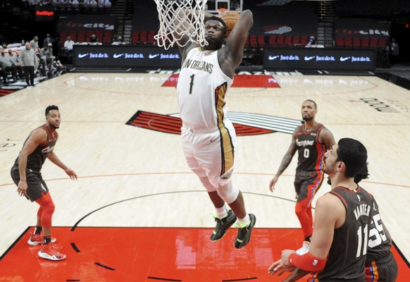 New Orleans Pelicans forward Zion Williamson goes up for a dunk during the first half of an NBA basketball game in Portland, Ore., Thursday, March 18, 2021. (AP Photo/Steve Dykes)