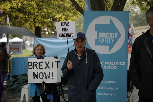 Pro-Brexit leave the European Union supporters hold placards opposite the Houses of Parliament in London, Thursday, Oct. 24, 2019. Britain&#039;s Prime Minister Boris Johnson won Parliament&#039;s bac ...